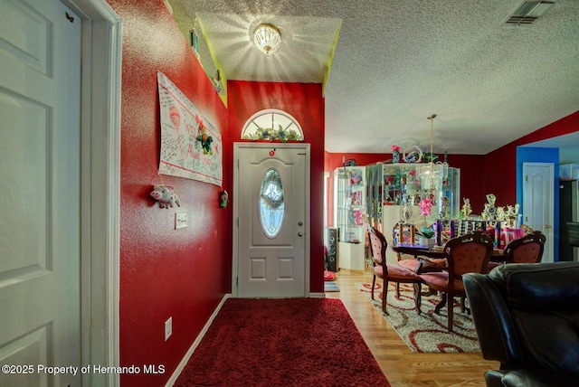 entryway featuring a textured ceiling and light wood-type flooring