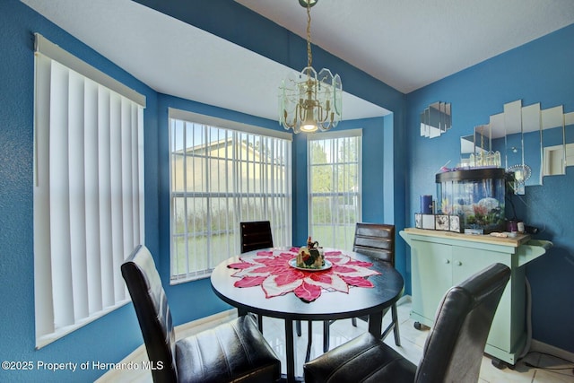 tiled dining room featuring a notable chandelier