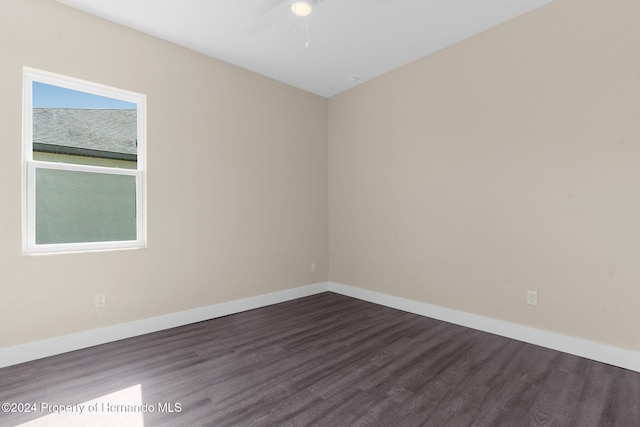 unfurnished room with dark hardwood / wood-style floors