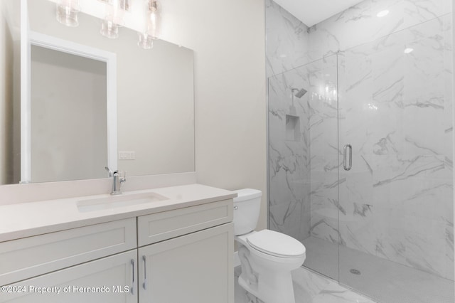 bathroom featuring vanity, toilet, and an enclosed shower