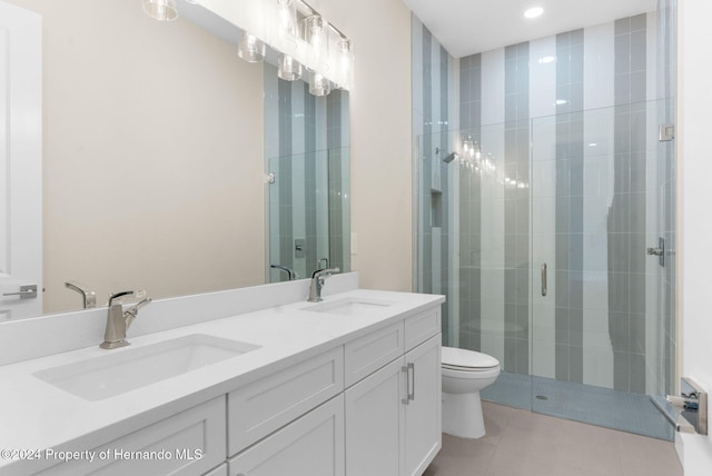 bathroom with tile patterned floors, vanity, toilet, and walk in shower