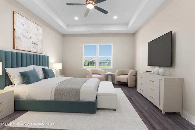 bedroom with a raised ceiling, ceiling fan, and dark hardwood / wood-style floors