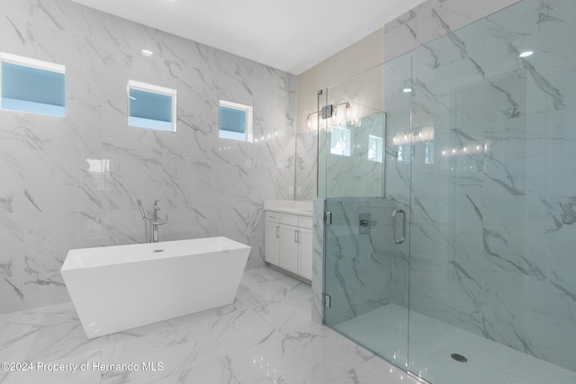 bathroom featuring vanity and shower with separate bathtub