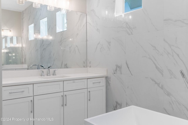 bathroom featuring vanity and a tub