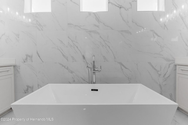 bathroom featuring vanity and a tub