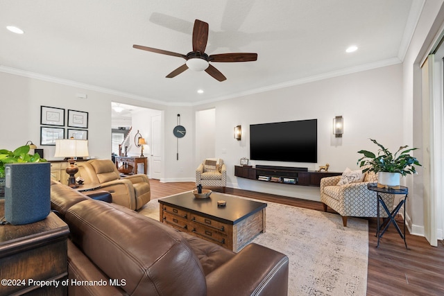 living room featuring hardwood / wood-style floors, ceiling fan, and ornamental molding