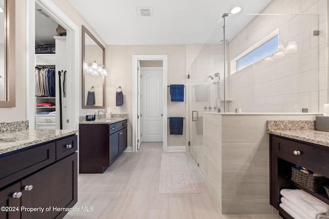 bathroom with vanity and a shower with shower door