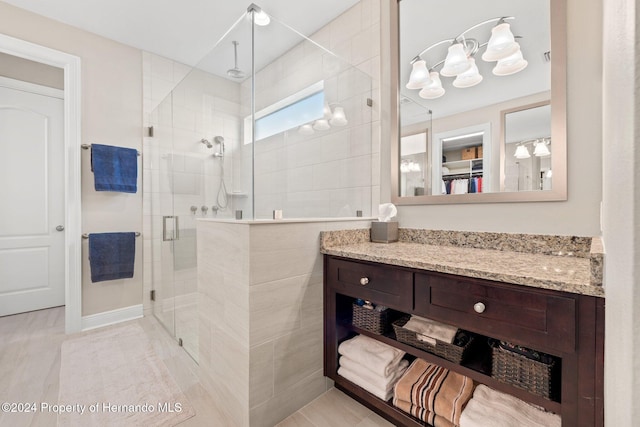 bathroom with vanity, tile patterned floors, and walk in shower