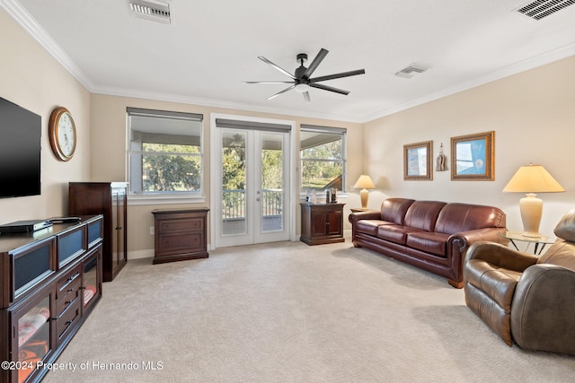 carpeted living room with french doors, ceiling fan, and ornamental molding