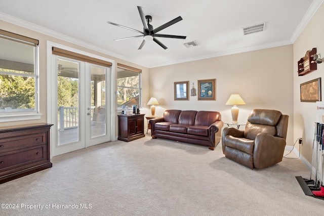 living room with french doors, light colored carpet, ceiling fan, and ornamental molding