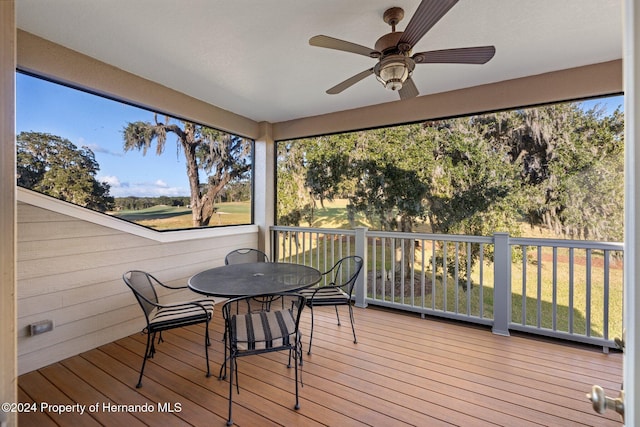 sunroom with a wealth of natural light and ceiling fan