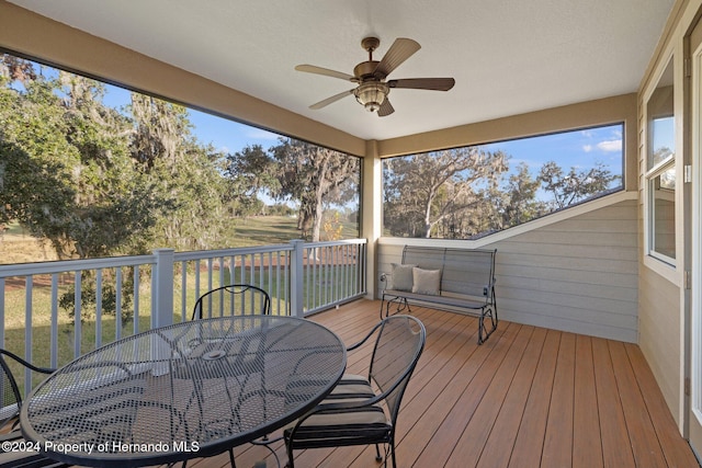 sunroom featuring ceiling fan