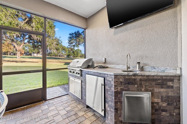 interior space with grilling area, sink, and exterior kitchen