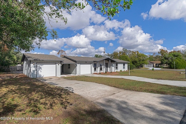 single story home featuring a front yard and a garage