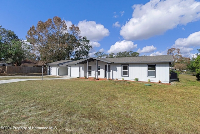 ranch-style home with a garage and a front yard