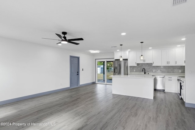 kitchen featuring stainless steel appliances, ceiling fan, pendant lighting, white cabinets, and a center island