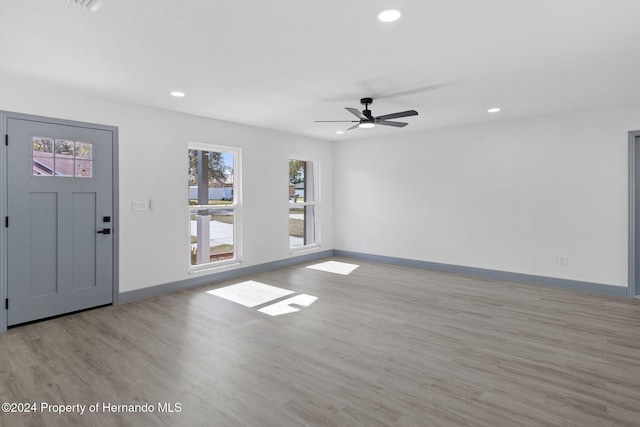 interior space with ceiling fan and light hardwood / wood-style floors