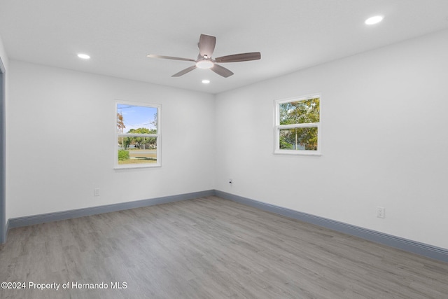 unfurnished room featuring light hardwood / wood-style flooring and ceiling fan