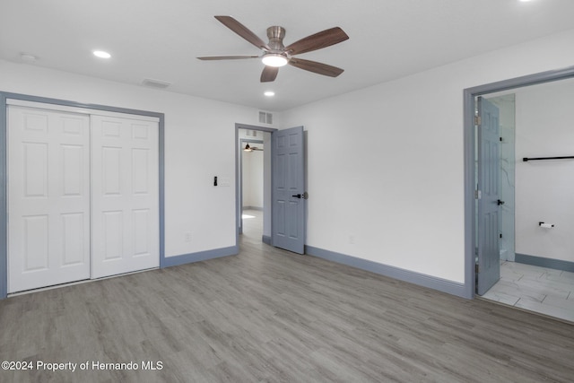 unfurnished bedroom with ceiling fan, light hardwood / wood-style floors, and a closet