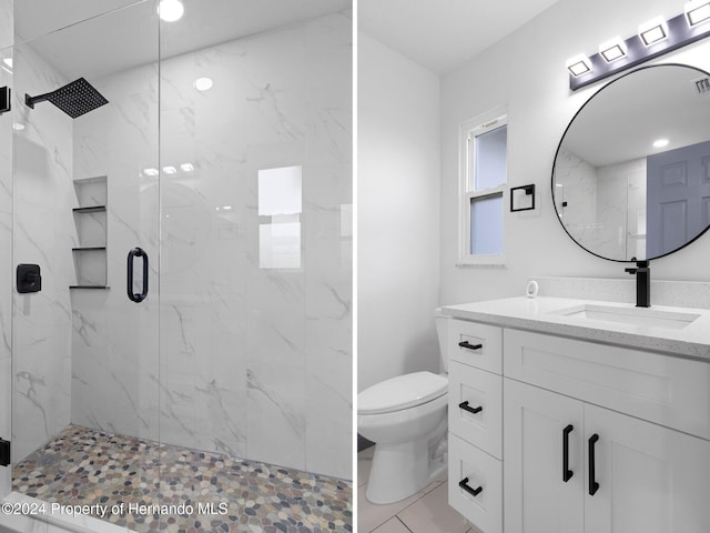 bathroom featuring tile patterned flooring, vanity, toilet, and a shower with door