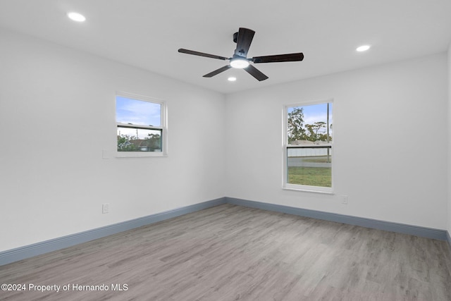 spare room featuring light hardwood / wood-style floors and ceiling fan