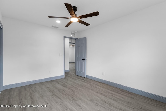 spare room featuring light wood-type flooring and ceiling fan