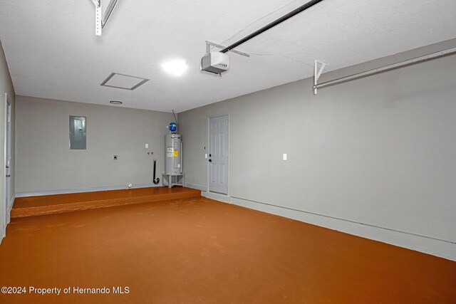 garage with a garage door opener, electric panel, and water heater