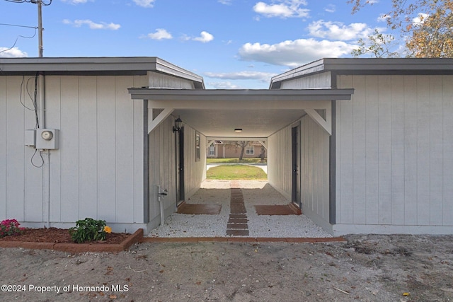 doorway to property featuring a carport