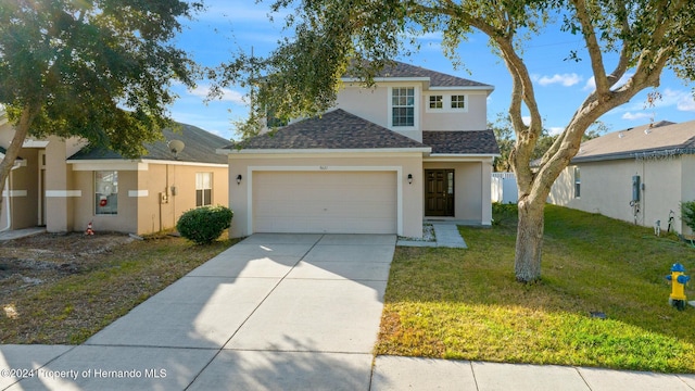 view of front of house with a front yard and a garage