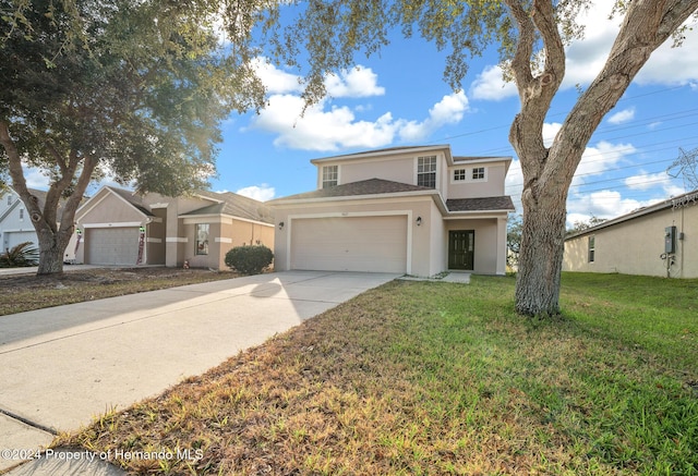 view of front of home with a front yard and a garage