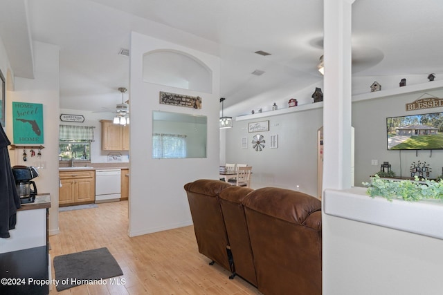 living room with light hardwood / wood-style flooring, ceiling fan, lofted ceiling, and sink