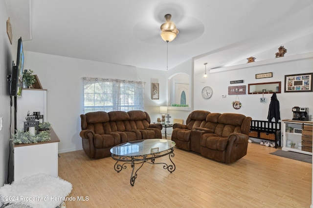 living room featuring light wood-type flooring, vaulted ceiling, and ceiling fan