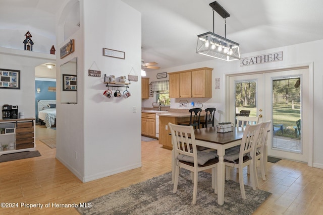 dining area featuring ceiling fan, sink, light hardwood / wood-style floors, and french doors