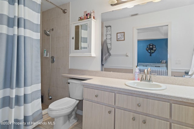 bathroom with curtained shower, tile patterned flooring, vanity, and toilet