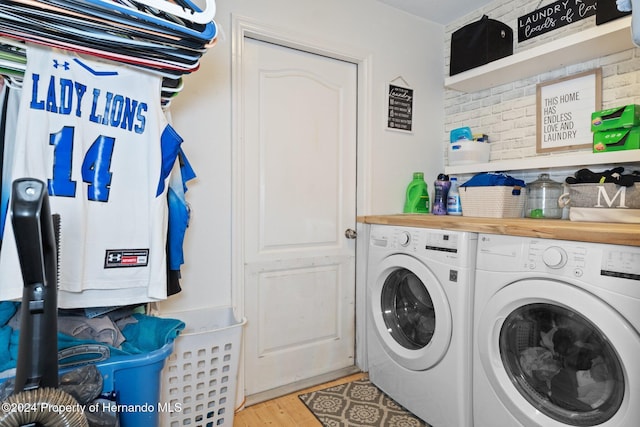 laundry room featuring separate washer and dryer and light wood-type flooring