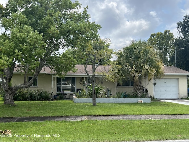 ranch-style home with a front yard and a garage