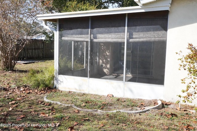 view of side of home featuring a sunroom