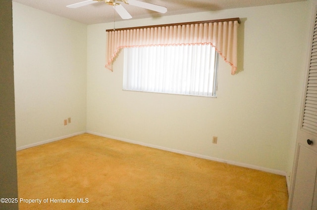 unfurnished room featuring ceiling fan and light colored carpet