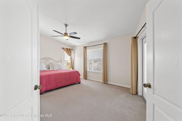 carpeted bedroom with ceiling fan and vaulted ceiling