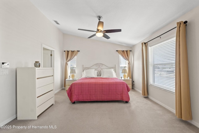 carpeted bedroom with vaulted ceiling and ceiling fan