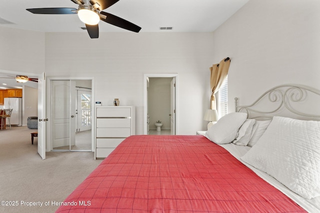 bedroom featuring carpet flooring, ceiling fan, and white refrigerator