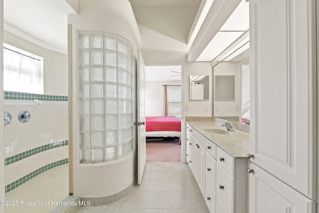 bathroom with vanity, tile patterned floors, and a shower