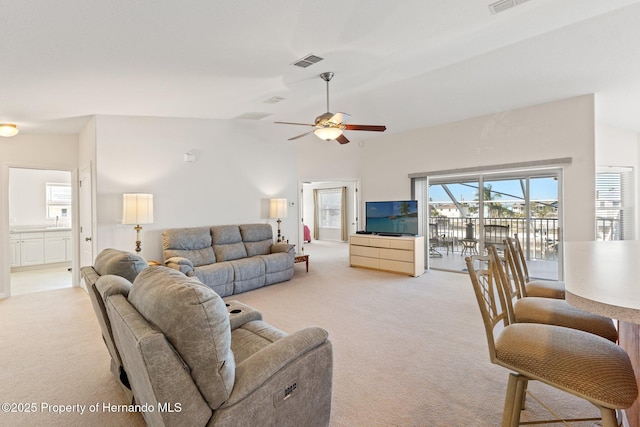 living room with vaulted ceiling, sink, light carpet, and ceiling fan