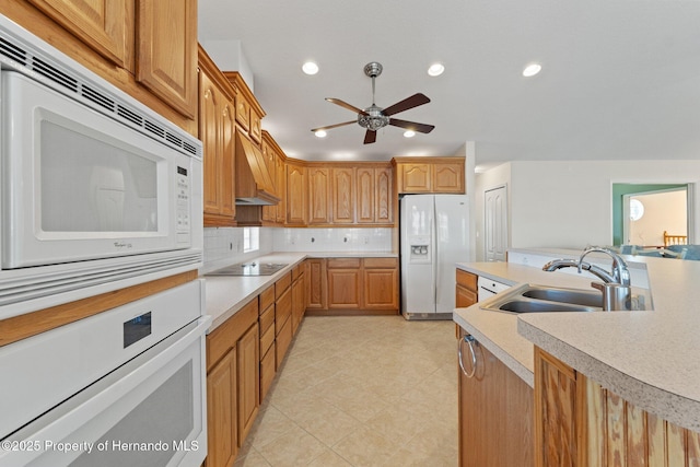 kitchen with sink, white appliances, ceiling fan, premium range hood, and tasteful backsplash