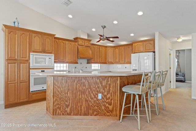 kitchen with white appliances, premium range hood, a kitchen island with sink, decorative backsplash, and vaulted ceiling