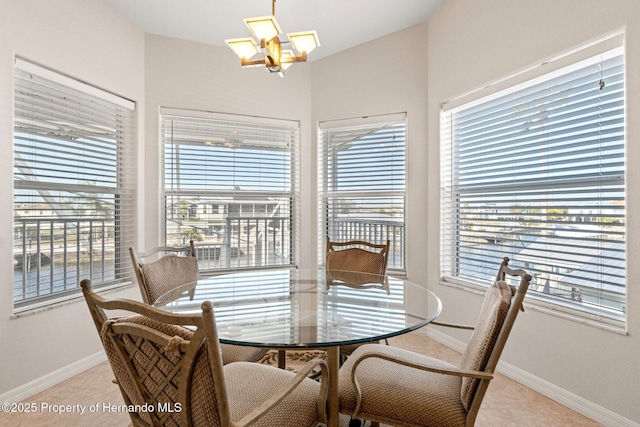 dining area with light tile patterned floors and a notable chandelier