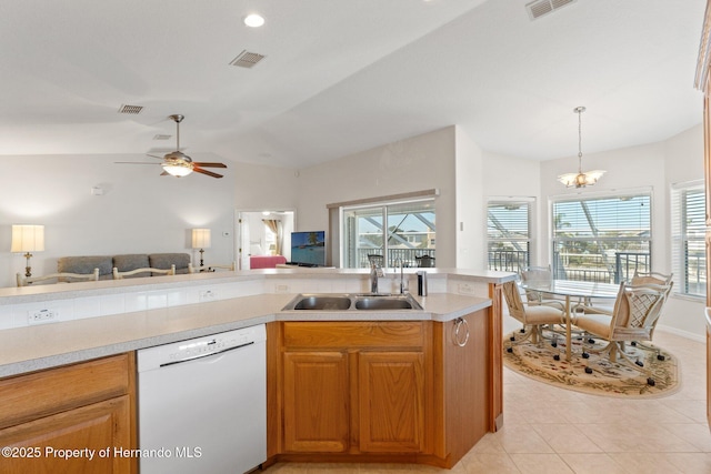 kitchen with lofted ceiling, sink, hanging light fixtures, white dishwasher, and light tile patterned flooring