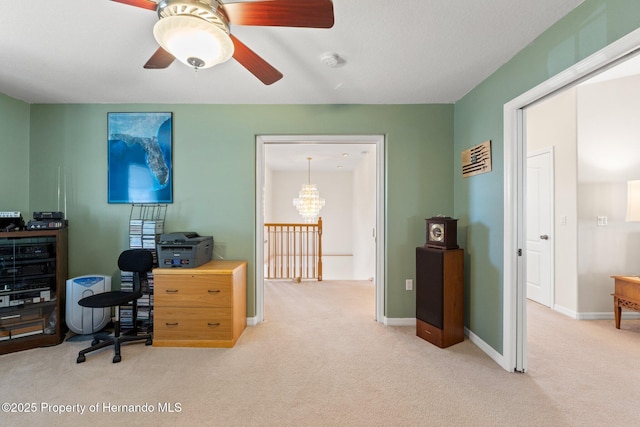 carpeted home office with ceiling fan with notable chandelier