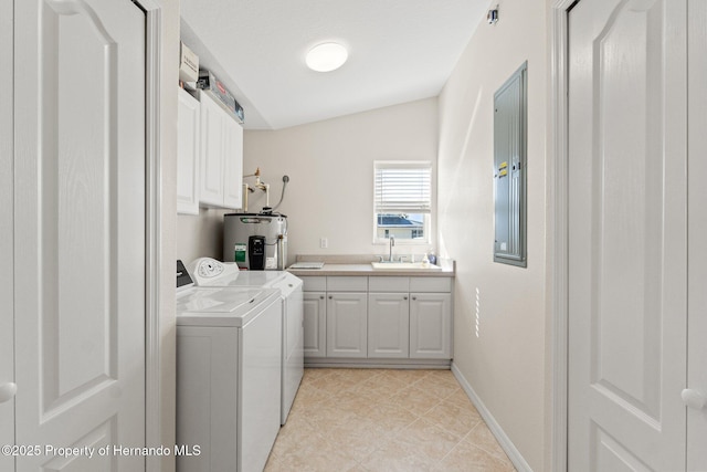 clothes washing area with sink, electric panel, cabinets, electric water heater, and independent washer and dryer