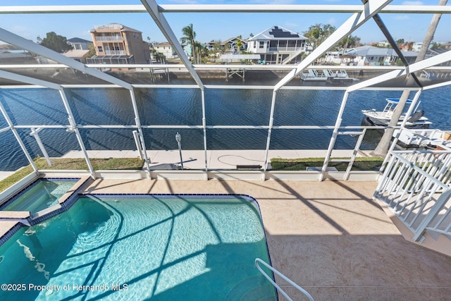 view of pool featuring a water view and a patio